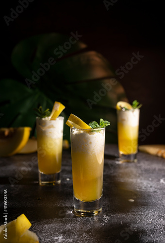 Photo for bar concept or magazines. Glasses of melon drink on dark background. Fresh and summer drink. laid out in layers with whipped cream