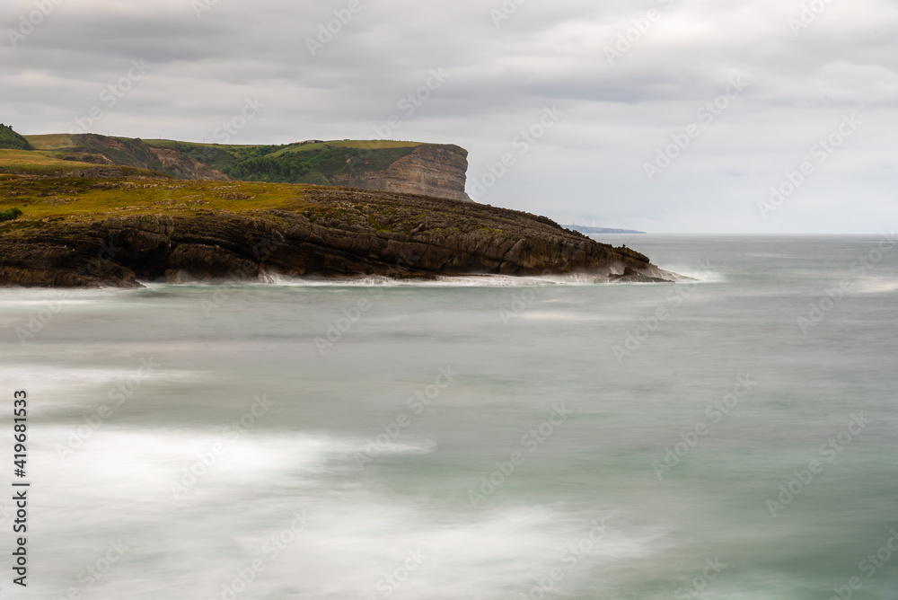 Long exposure view of rocky coast in Ajo, Cantabria, Spain.