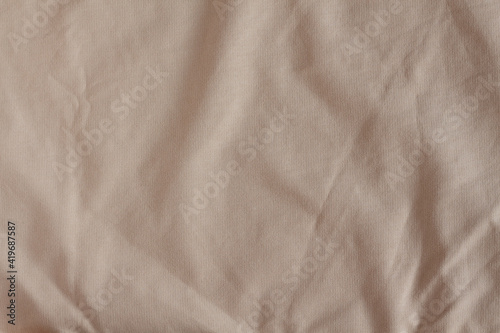Peach color natural cotton fabric texture. Crumpled.