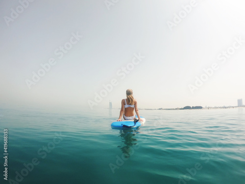 Woman sitting on the paddle board with a view on Burj Al Arab