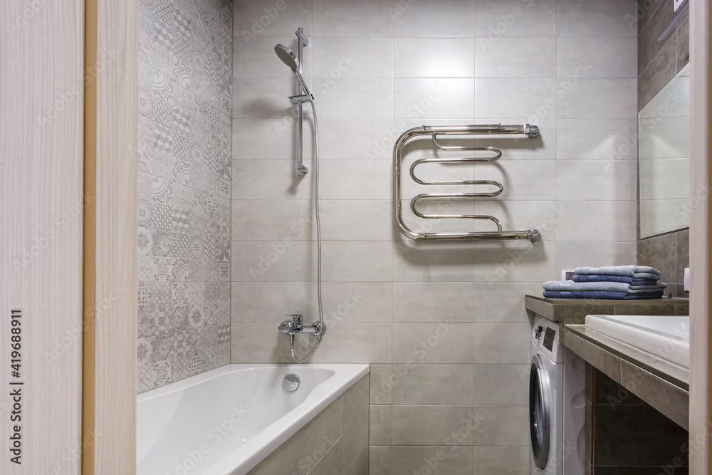 water tap sink with faucet in expensive loft bathroom. detail of a corner shower cabin with wall mount shower attachment