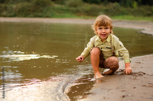 Fototapeta Naklejka Na Ścianę i Meble -  little child playing in the water