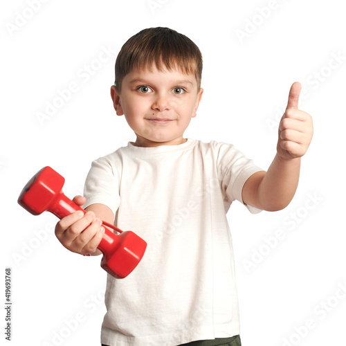 isolated child with a dumbbell in hand on white background. Baby shows a thumb