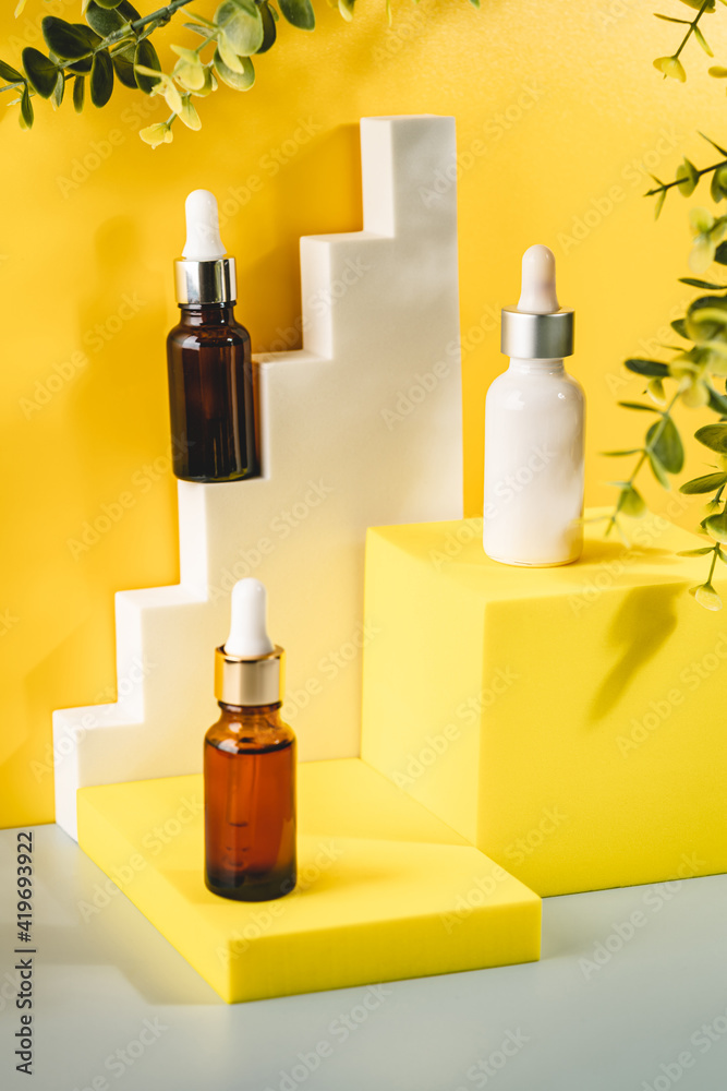 Glass cosmetic bottle with oil or serum for skin care on special podium on yellow background. Shadows Natural skin care concept. Harsh shadows