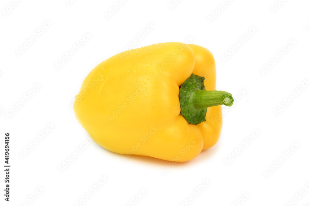 Yellow bell pepper with a green shank and water droplets on the peel. Yellow bell pepper with a green shank and water droplets on the peel.