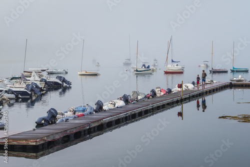 USA, Massachusetts, Cape Ann, Gloucester. Annisquam Harbor, boats in fog photo