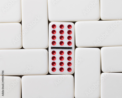 Obraz na plátně Double twelve domino with red dots surrounded by blank tiles