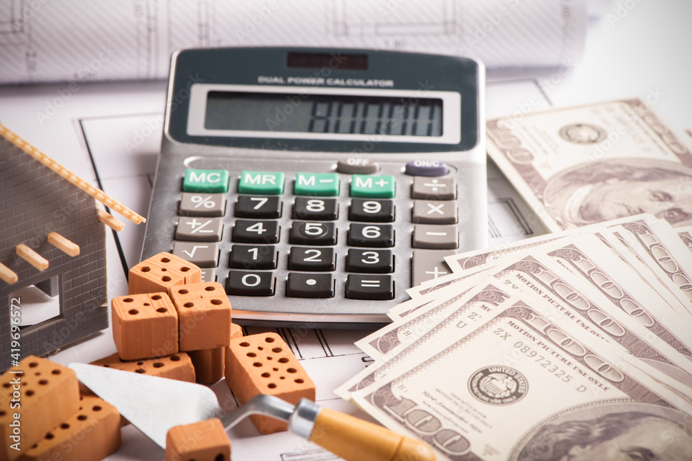 House model on background of U.S. one hundred dollar bills House model on background of U.S. one hundred dollar bills