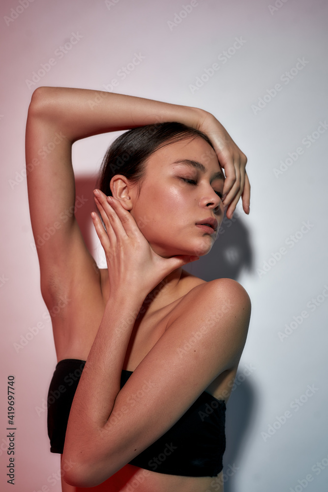 Healthy skin. Young gorgeous asian woman posing against light background, demonstrating her clean and soft face skin