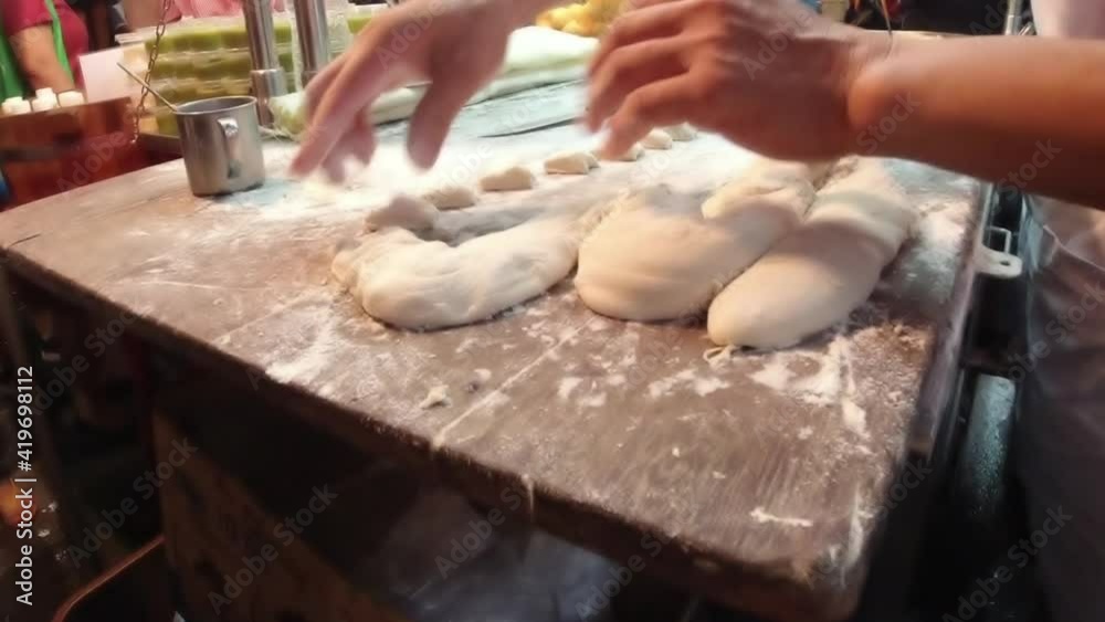 You tiao or Chinese Doughnut. Making Chinese deep-fried fluffy dough sticks. You tiao or Chinese Doughnut. Making Chinese deep-fried fluffy dough sticks.