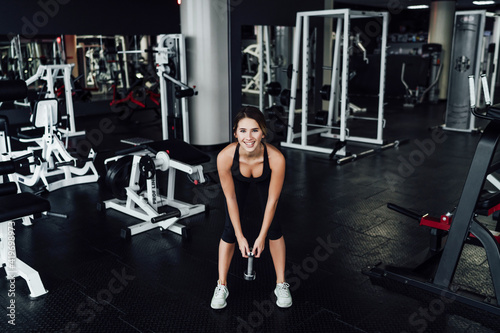 Athletic body, attractive girl in the gym with dumbbells in hand, healthy lifestyle, sports, lifestyle