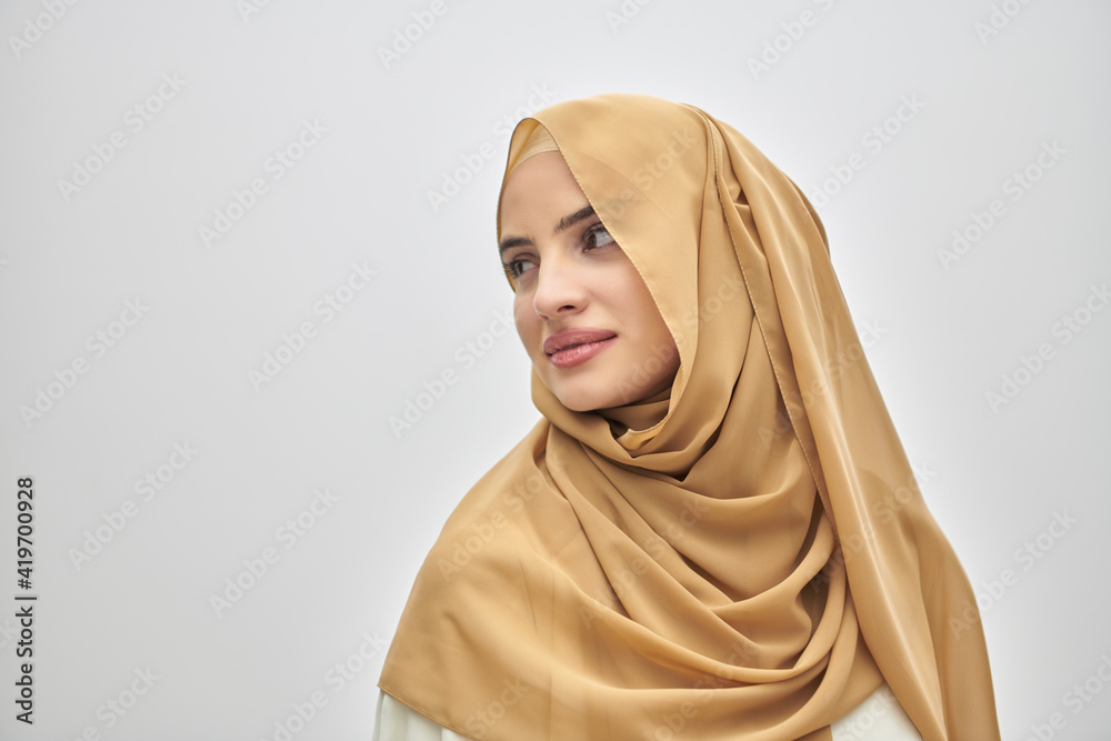 Portrait of young muslim woman wearing hijab on isolated white background Portrait of young muslim woman wearing hijab on isolated white background