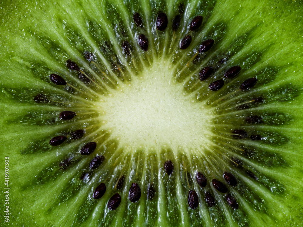 Macro view of fruit. Cut kiwifruit close-up background texture pattern. Macro view of fruit. Cut kiwifruit close-up background texture pattern.