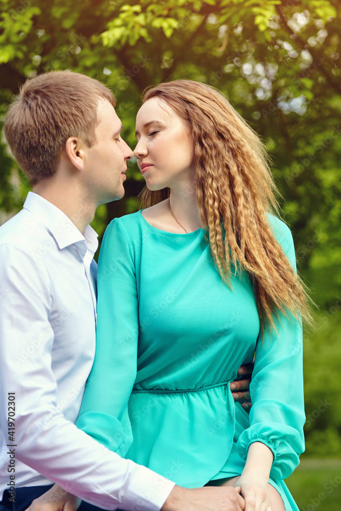 Young happy couple in love outdoors. loving man and woman in a park. Young happy couple in love outdoors. loving man and woman in a park.