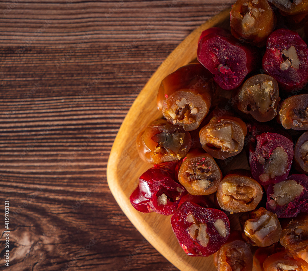 oriental sweet with nuts - churchkhela on a wood background oriental sweet with nuts - churchkhela on a wood background