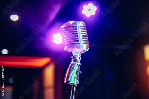 Close-up old retro vintage microphone on tinted color background copy space