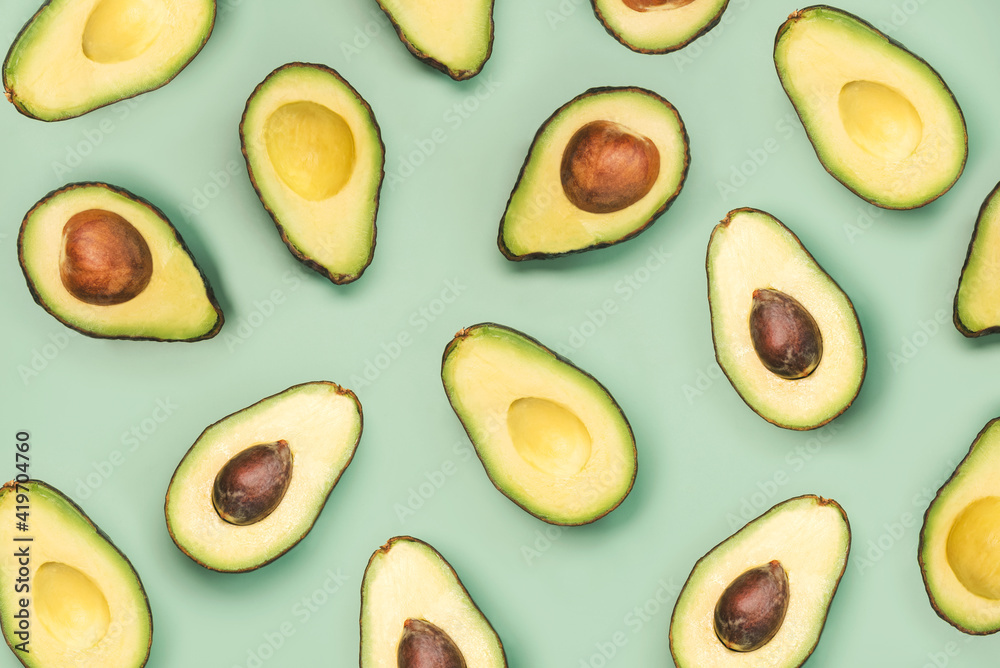 fresh ripe avocados pattern on a green background fresh ripe avocados pattern on a green background