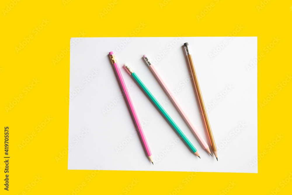 White sheet of paper with pencils, space for creativity. White sheet of paper with pencils, space for creativity.