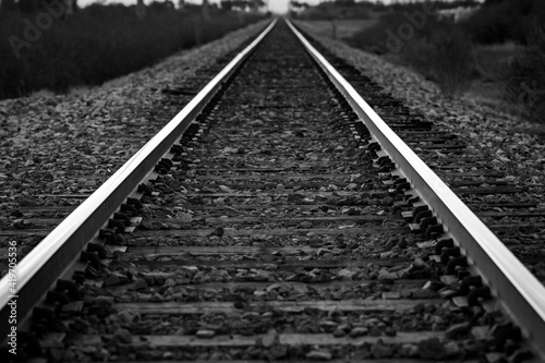 Railroad tracks disappearing into the distance in black and white