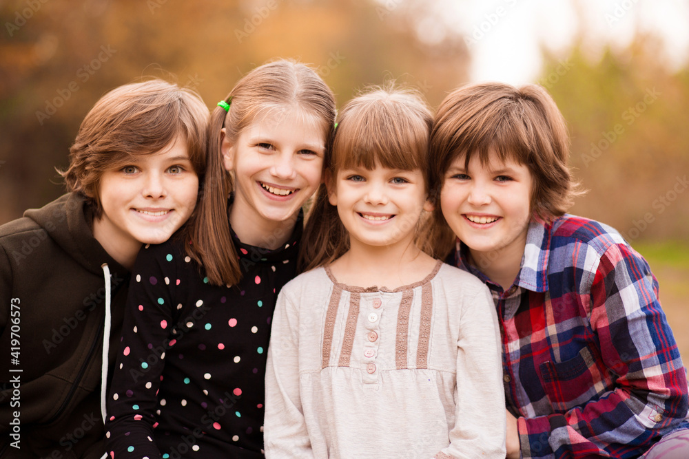 Fototapeta premium Four happy teenagers girls walking in autumn park . High quality photo