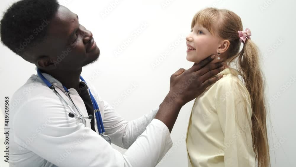 Little girl having a check up at pediatrician. The doctor is pulping and checking child's breathing, hearing and throat. Little girl having a check up at pediatrician. The doctor is pulping and checking child's breathing, hearing and throat.