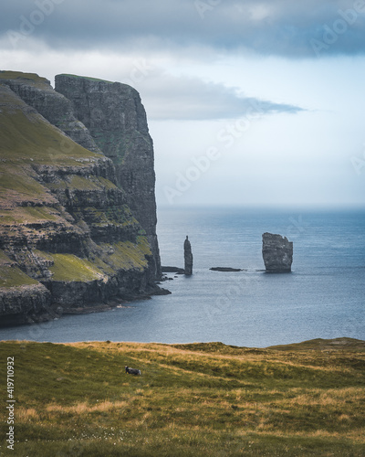 Risin and Kellingin rocks in the sea as seen from Tijornuvik bay on Streymoy on the Faroe Islands, Denmark, Europe