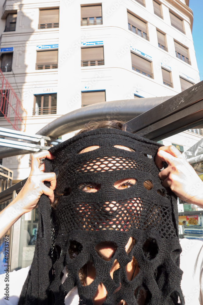 woman covering her face with a scarf