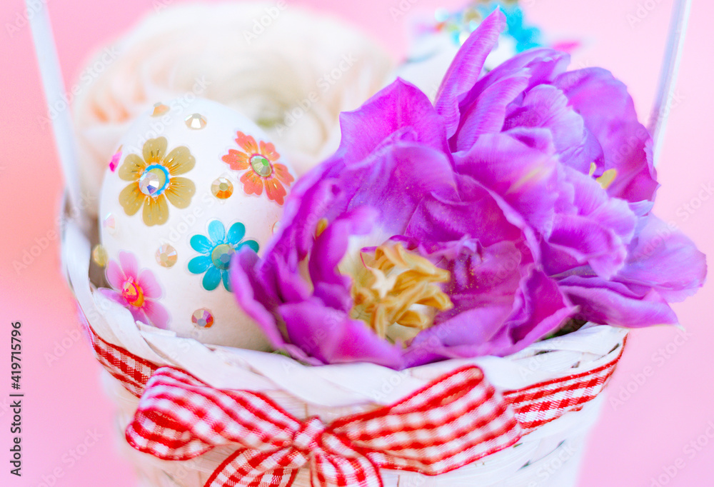 white Easter eggs and flowers in basket on pink background, a minimal creative concept of a happy Easter