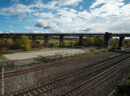 Old iron viaduct with modern railroad underneath