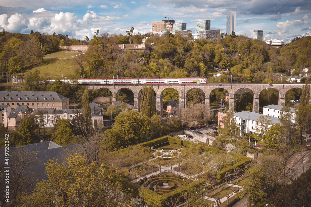 Photo of the lower city with a Park and a train running over a viaduct