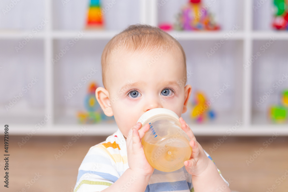 Cute caucasian baby boy drinking from bottle. Cute caucasian baby boy drinking from bottle.