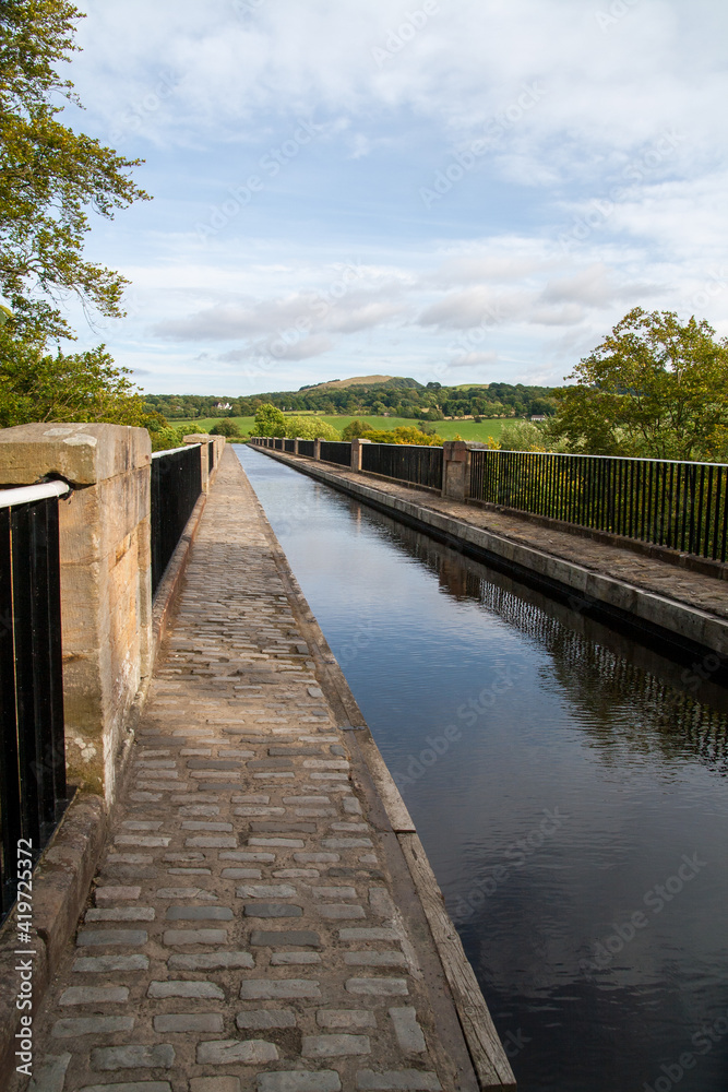 Scottish  aquaduct over a river near Linlithgow with blue sky and hills in the distance