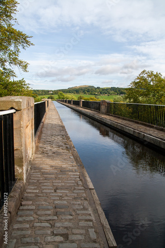 Scottish  aquaduct over a river near Linlithgow with blue sky and hills in the distance © Alan