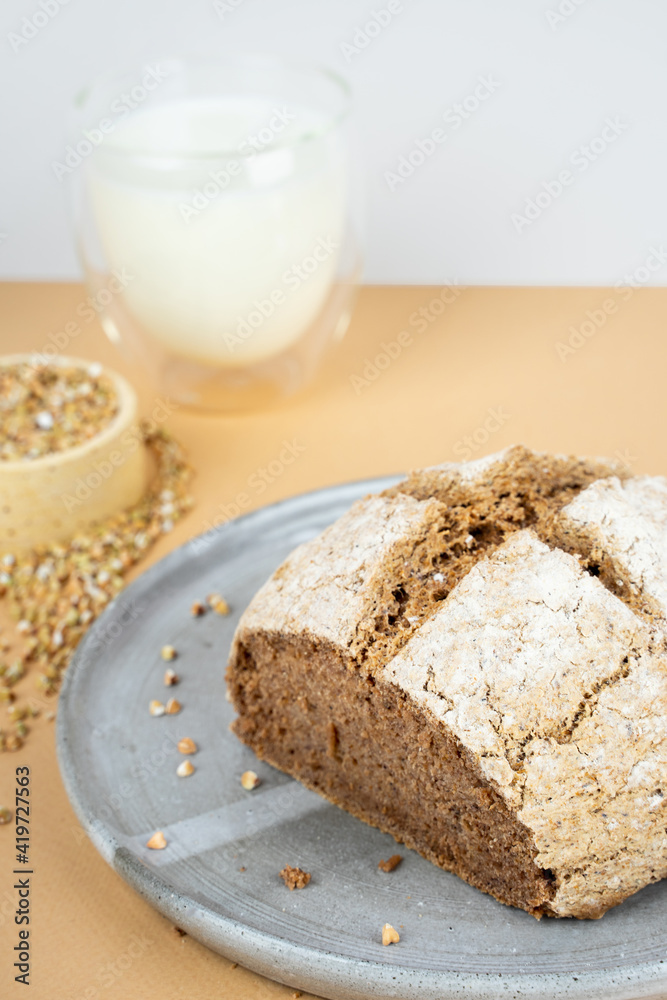 creative beige background with green buckwheat bread and organic buckwheat milk. Harmless, wellness, gluten free healthy baking. Alternative bread. Copy spase creative beige background with green buckwheat bread and organic buckwheat milk. Harmless, wellness, gluten free healthy baking. Alternative bread. Copy spase