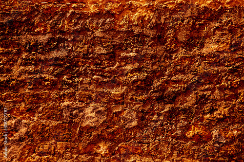 texture of a orange wall covered with volumetric plaster, space for text, space for copy
