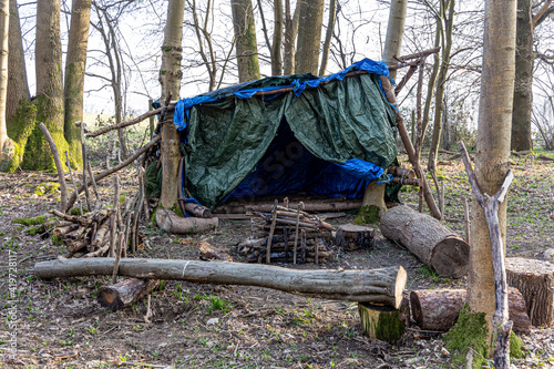Primitive survival shelter in the forest
