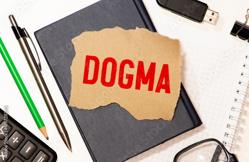 word dogma printed on white paper macro
