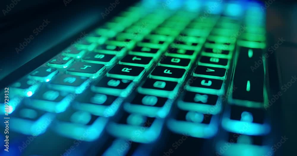 Close up of professional gaming keyboard with colorful LED backlight in multiple colors. Technology in gaming or developer industry. Desktop computer accessories for streaming work process