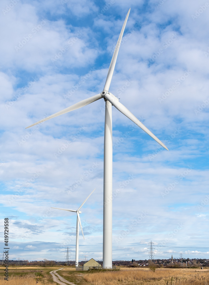 Renewable energy wind turbine in a field
