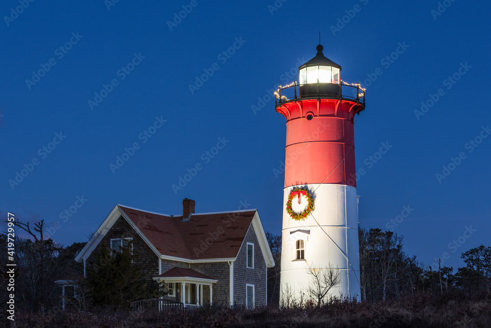 USA, Massachusetts, Cape Cod, Eastham. Nauset Light with Christmas wreath at dawn.