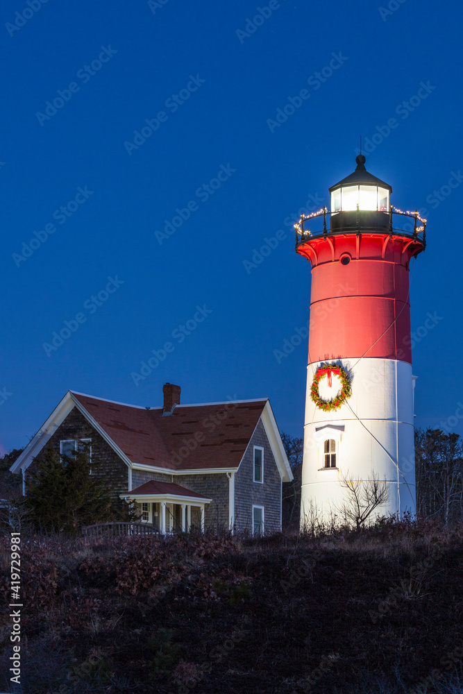 USA, Massachusetts, Cape Cod, Eastham. Nauset Light with Christmas wreath at dawn.