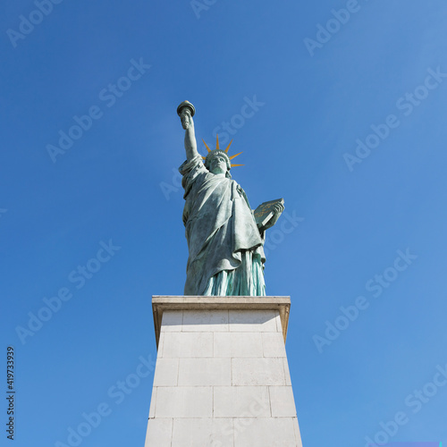 France, Ile-de-France, Paris, Replica of Statue of Liberty standing against clear blue sky photo