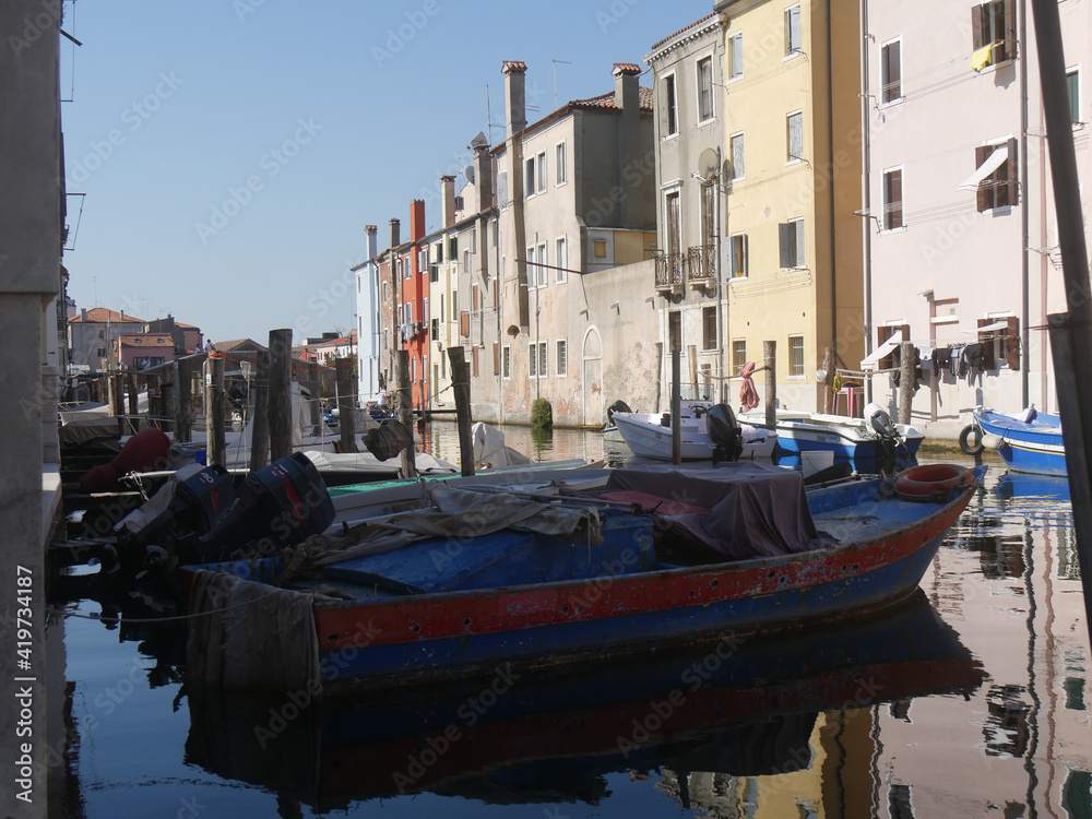 Chioggia, Vena Canal with colorful buildings and crossed by bridges reflected in the water