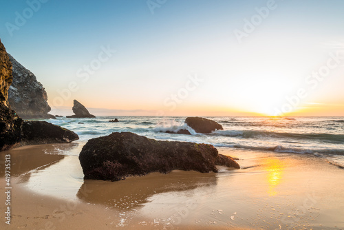 Beach with rocks at sunset
