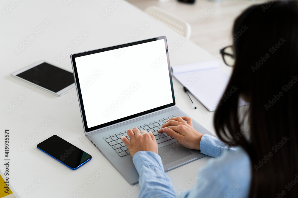 Businesswoman using laptop while working at office Businesswoman using laptop while working at office