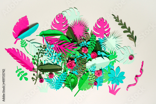 Green and pink paper plants with flowers over white background