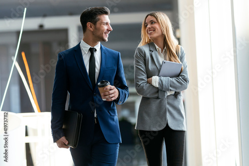 Colleague smiling while walking on office
