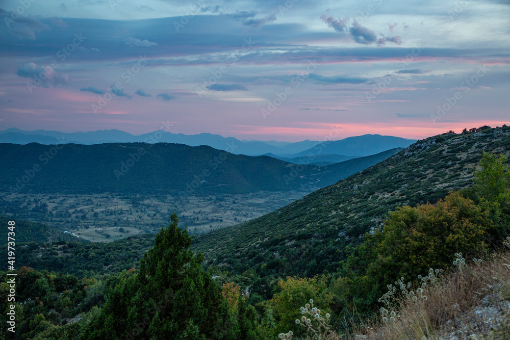 Greece, Epirus, Zagori, Pindos Mountains, Vikos National Park, View of mountains, valley and scenic sunset Greece, Epirus, Zagori, Pindos Mountains, Vikos National Park, View of mountains, valley and scenic sunset