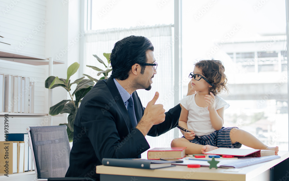 Father playing and taking care his daughter while working Father playing and taking care his daughter while working