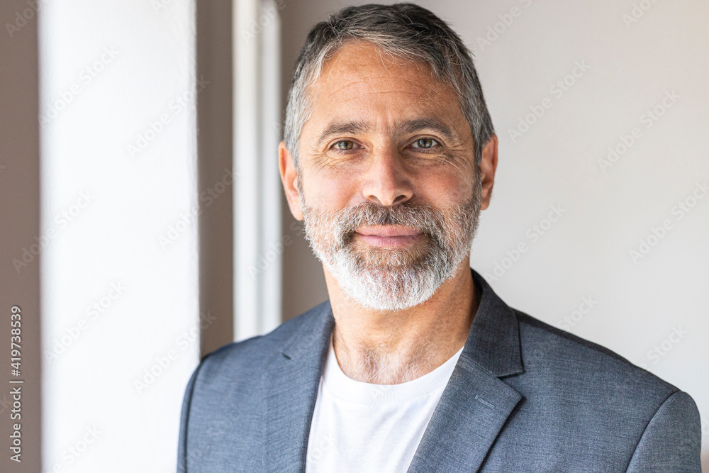 Entrepreneur smiling while standing at home Entrepreneur smiling while standing at home